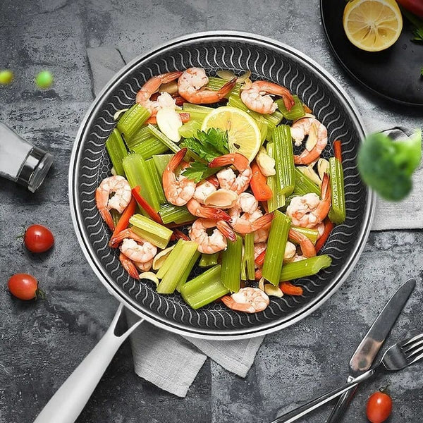 stainless_steel_skillet_frying_shrimps.